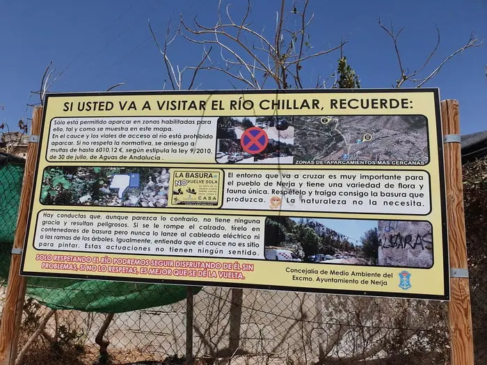 Nerja Town Hall sign with rules for visiting the Río Chillar: parking and litter