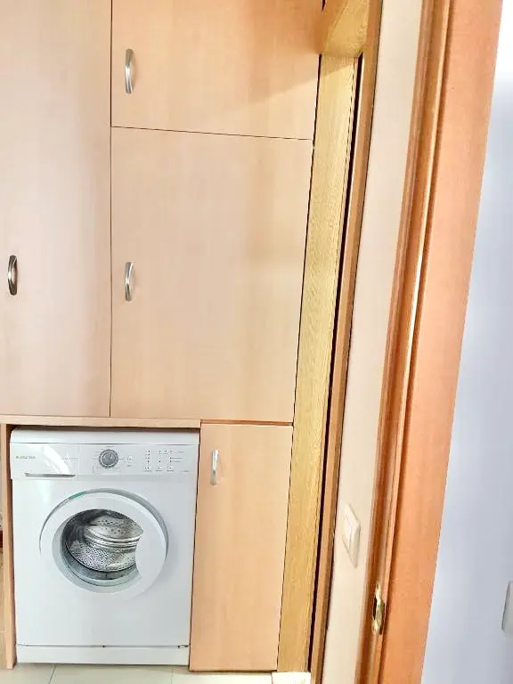 Lavadora integrada entre los armarios de la cocina