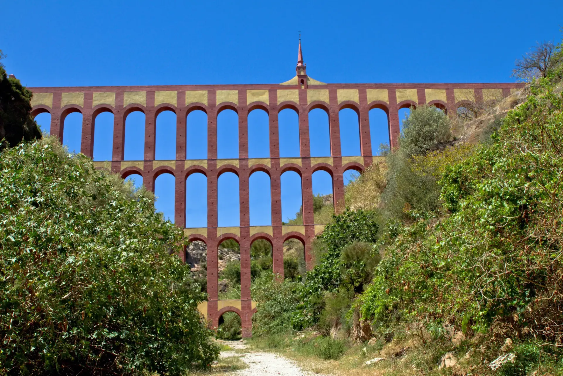 Arcos de ladrillo del acueducto vistos desde el camino del fondo del barranco