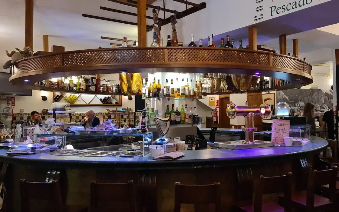 Barra circular con vitrina de pescado, grifo de cerveza y estanterías de bebidas