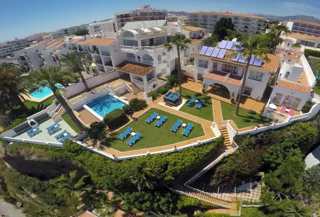 Vista aérea del Hotel Paraíso del Mar con jardines, piscinas y tumbonas sobre el acantilado