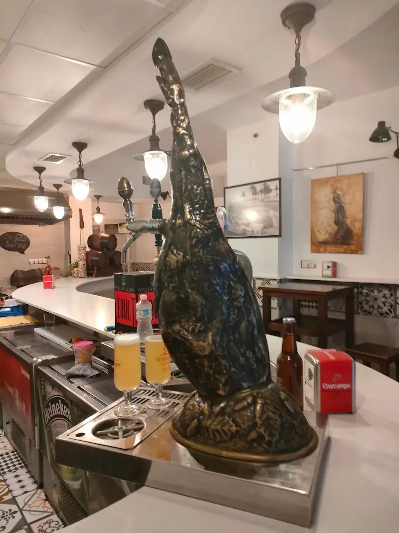 Grifo de cerveza con forma de pata de jamón y dos cañas recién tiradas en la barra
