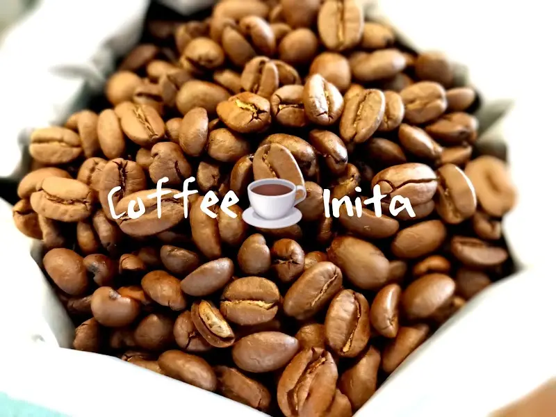 Granos de café tostado en un saco con el rótulo Coffee Inita