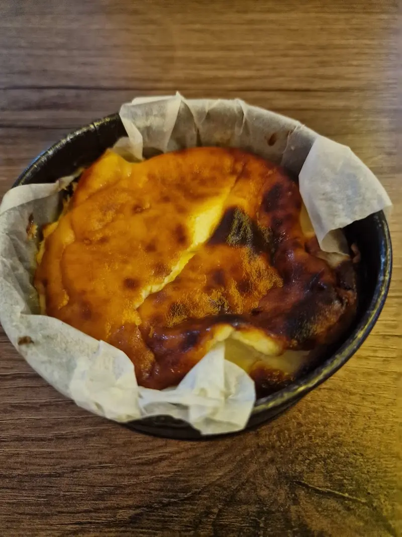 Tarta de queso horneada con la superficie tostada en su molde con papel