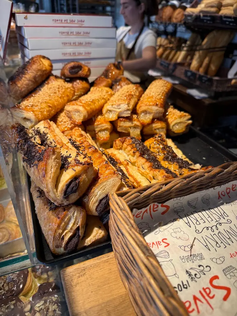 Napolitanas de chocolate y hojaldres con azúcar en el mostrador, junto a una cesta
