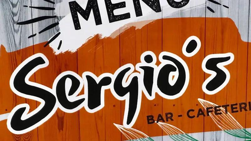 Portada de la carta de Sergio's con el logo sobre fondo de madera naranja