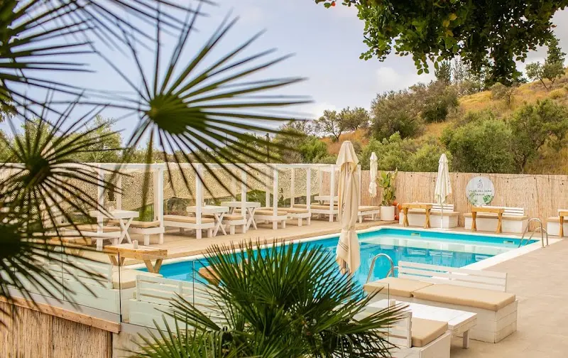 Piscina del Villa del Mar – Nerja Camping con hamacas, sombrillas y monte al fondo